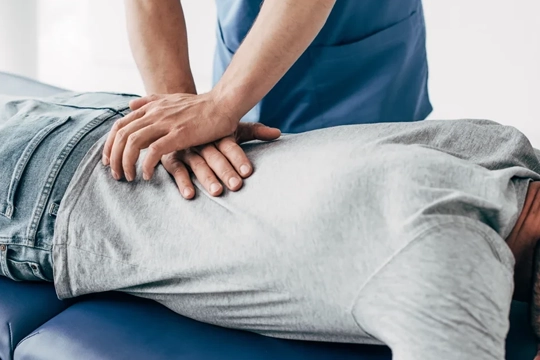 Chiropractor giving a back adjustment.